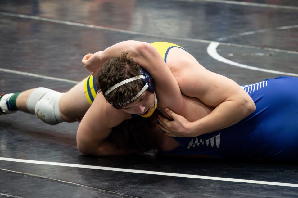 Hillsdale wrestler John Petersen goes for a pin in the 215-pound championship match.