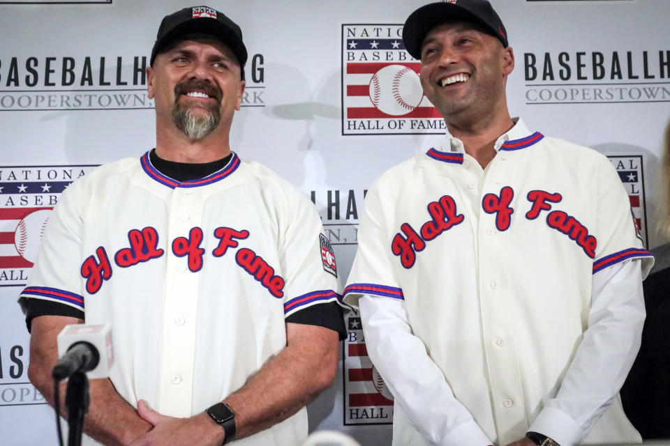 FILE - In this Jan. 22, 2020, file photo, former New York Yankees shortstop Derek Jeter, right, and former Colorado Rockies outfielder Larry Walker pose after receiving their Baseball Hall of Fame jerseys during a baseball news conference in New York. Jeter and Walker and the rest of this year’s Baseball Hall of Fame class will have to wait for their big moment at Cooperstown. The Hall of Fame announced Wednesday, April 29, 2020, that it has canceled its July 26 induction ceremony because of the coronavirus outbreak. (AP Photo/Bebeto Matthews, File)