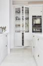 <p>Not an inch is overlooked in this bespoke white kitchen by Blakes London. White kitchen tiles add texture and a touch of the unexpected in this display cabinet, as well as being a fitting backdrop to patterned crockery and glassware.</p><p>Pictured: <a href="https://www.blakeslondon.com/wandsworth/" rel="nofollow noopener" target="_blank" data-ylk="slk:Kitchen by Blakes London;elm:context_link;itc:0;sec:content-canvas" class="link ">Kitchen by Blakes London</a></p>