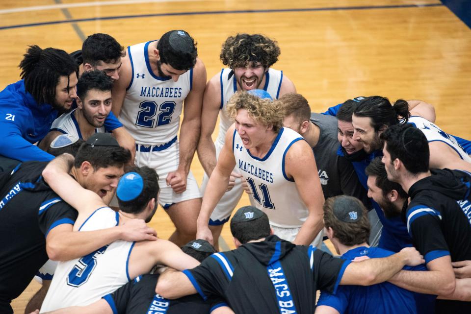 Yeshiva University vs. Illinois Wesleyan University at the Max Stern Athletic Center on Thursday, December 30, 2021. (Center) Yeshiva University #11 Ryan Turell with teammates before the start of the game.

Yeshiva Vs Illinois Wesleyan