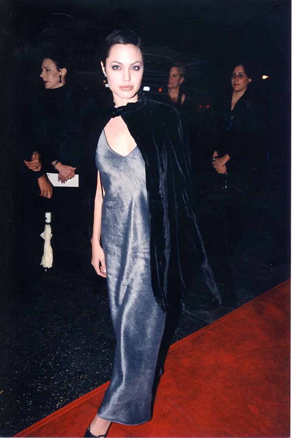 <p>Angelina worked this silver dress and cape at an awards ceremony back in 1997. [Photo: Getty] </p>