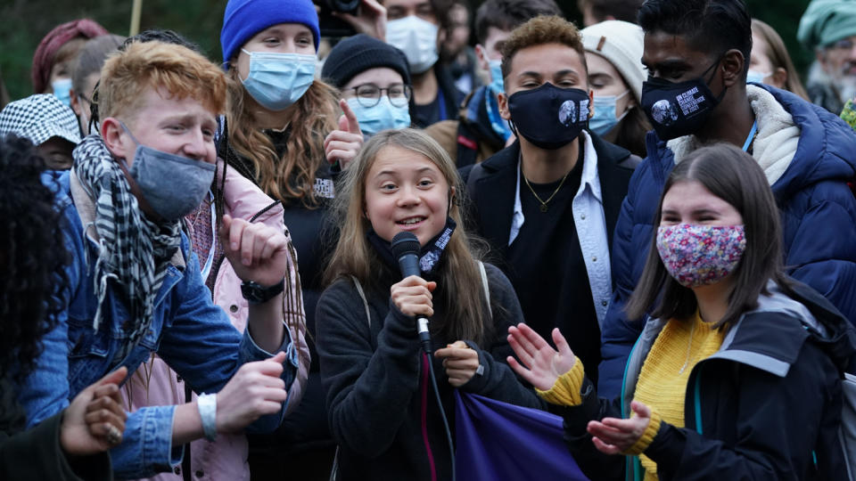 Greta Thunberg holds a microphone as she stands alongside fellow climate activists during a demonstration at Festival Park, Glasgow, on the first day of the COP26 summit.