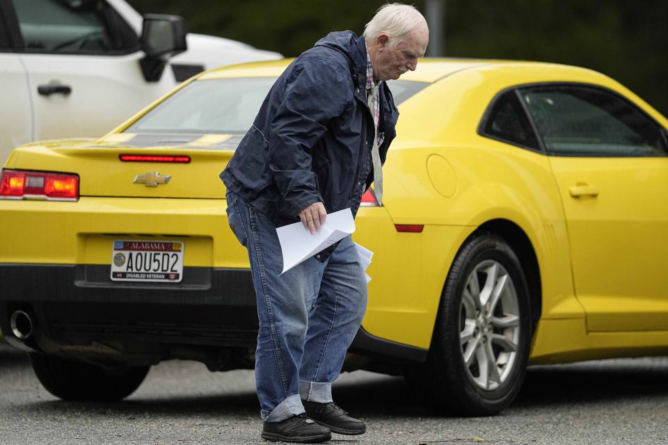 Robert Gene Booker, running for Russell County commissioner walks in a parking lot outside a polling facility at the Seale Courthouse in Russell County during a primary election, Tuesday, March 5, 2024, in Seale, Ala. Fifteen states and a U.S. territory hold their 2024 nominating contests on Super Tuesday this year. (AP Photo/Mike Stewart)