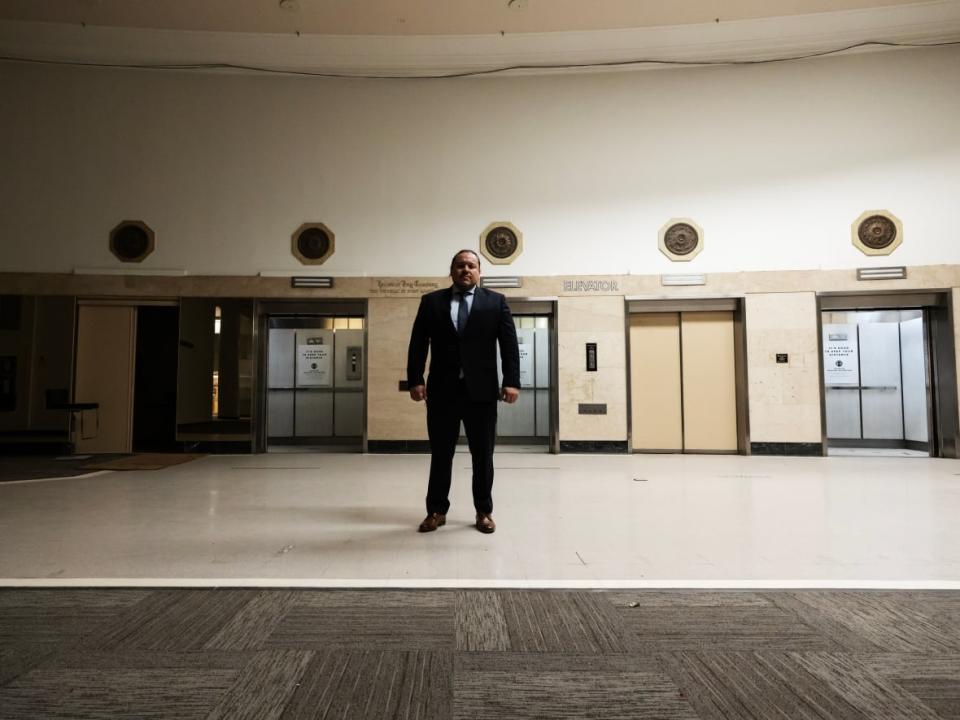 Jerry Daniels, grand chief of the Southern Chiefs' Organization, stands in front of the elevators on the main floor of the former Bay building in downtown Winnipeg. The elevators are slated to be removed as part of the redevelopment of the structure into Wehwehneh Bahgahkinahgohn. (Prabhjot Singh Lotey/CBC - image credit)