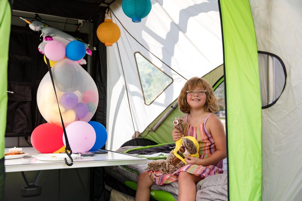 Brevard 9-year-old Annie, who suffers from congenital heart disease, poses inside her new GO Camper Trailer, which was given to her by Make-A-Wish Central & Western North Carolina and SylvanSport.
