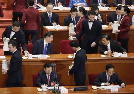 Chinese President Xi Jinping (L) talks with Liu Yunshan, member of the Standing Committee of the Political Bureau of the Communist Party of China (CPC) Central Committee during the opening of the annual full session of the National People's Congress, the country's parliament, at Great Hall of the People, in Beijing, March 5, 2015. REUTERS/Jason Lee