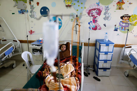 A boy lies on a bed at a cancer treatment center in Sanaa, Yemen, February 11, 2017. REUTERS/Khaled Abdullah