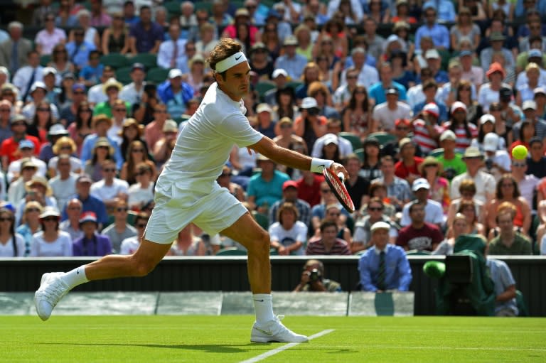 Switzerland's Roger Federer hits a return against US player Sam Querrey during their men's singles second round match on day four of the 2015 Wimbledon Championships at Wimbledon, southwest London, on July 2, 2015