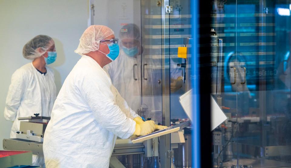 Catalent employees work on producing doses of the Moderna COVID-19 vaccine at the company’s Bloomington facility on Dec. 15, 2020. (Rich Janzaruk / Herald-Times)