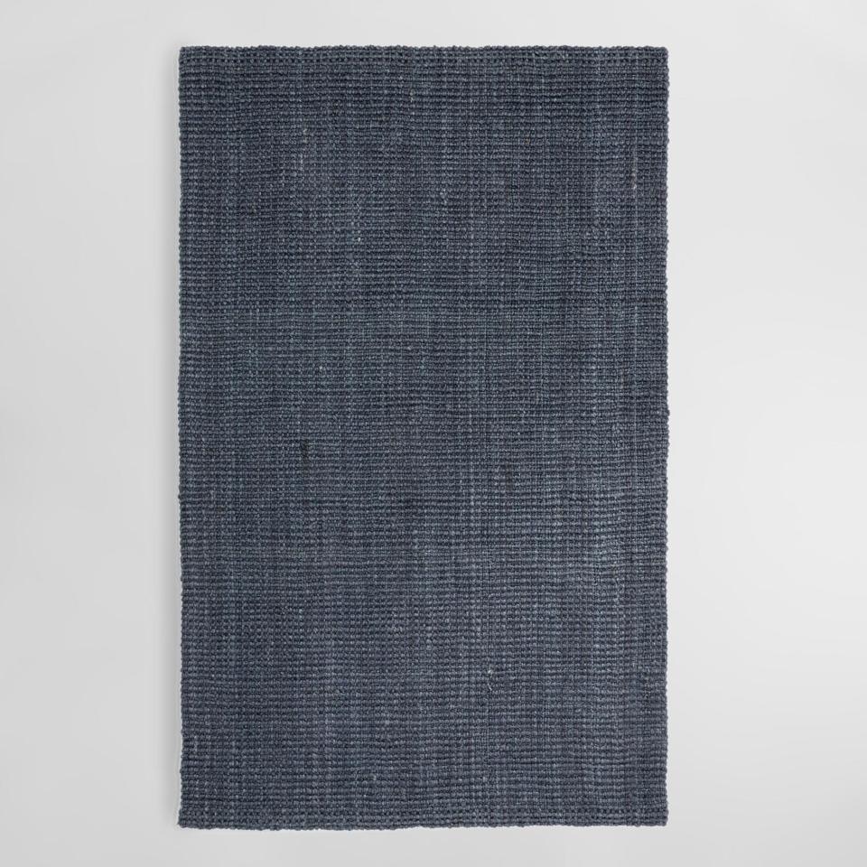 My new apartment was looking <em>suuuper</em> depressing without a rug. It was time. I knew I wanted a jute rug because my bank account is looking very sad and they're notoriously inexpensive (<a rel="nofollow noopener" href="https://www.architecturaldigest.com/story/round-jute-rugs-are-making-a-comeback?mbid=synd_yahoo_rss" target="_blank" data-ylk="slk:Amanda told me so;elm:context_link;itc:0;sec:content-canvas" class="link ">Amanda told me so</a>). This charcoal one from World Market was the exact color I was looking for and is insanely cheap considering how big it is. In person, it's a little more blue and the weave is pretty bumpy underfoot, but both didn't bother me after a day. Most important, it's <em>shockingly</em> soft. <strong>—Lindsey, Clever home editor</strong><br> <a rel="nofollow noopener" href="https://www.worldmarket.com/product/charcoal-gray-jute-boucle-area-rug.do" target="_blank" data-ylk="slk:SHOP NOW;elm:context_link;itc:0;sec:content-canvas" class="link ">SHOP NOW</a>: 8' x 10' Charcoal gray jute bouclé area rug by Cost Plus World Market, $270, worldmarket.com