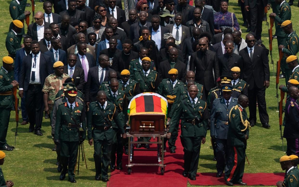 Robert Mugabe's coffin arrives for a state funeral at Harare's national stadium - AP