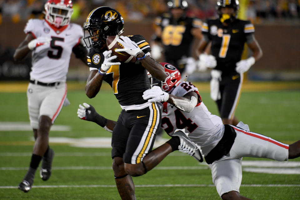 Missouri wide receiver Dominic Lovett (7) catches a pass as Georgia defensive back Malaki Starks (24) defends during the first half of an NCAA college football game Saturday, Oct. 1, 2022, in Columbia, Mo. (AP Photo/L.G. Patterson)