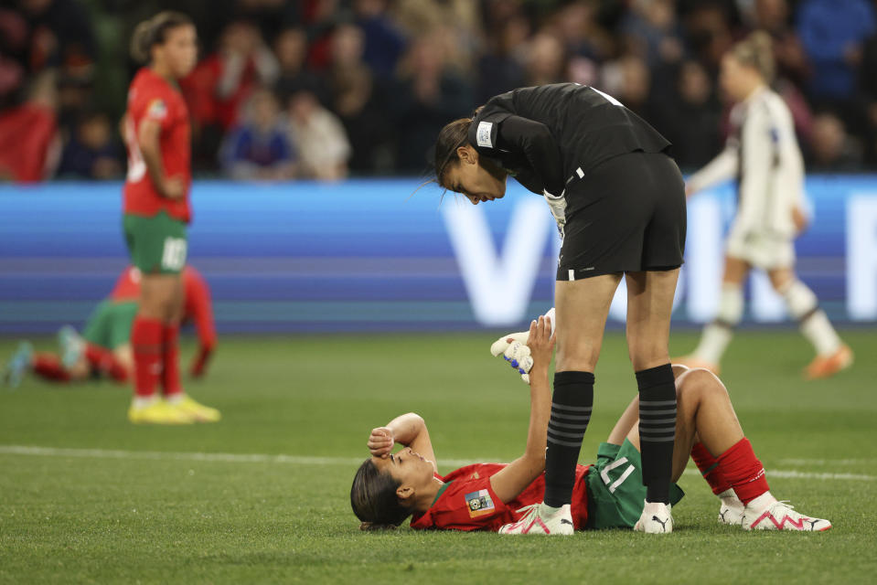 Morocco's goalkeeper Khadija Er-Rmichi talks to teammate Hanane Ait El Haj, on the ground, at the end of the Women's World Cup Group H soccer match between Germany and Morocco in Melbourne, Australia, Monday, July 24, 2023. Germany won 6-0. (AP Photo/Hamish Blair)