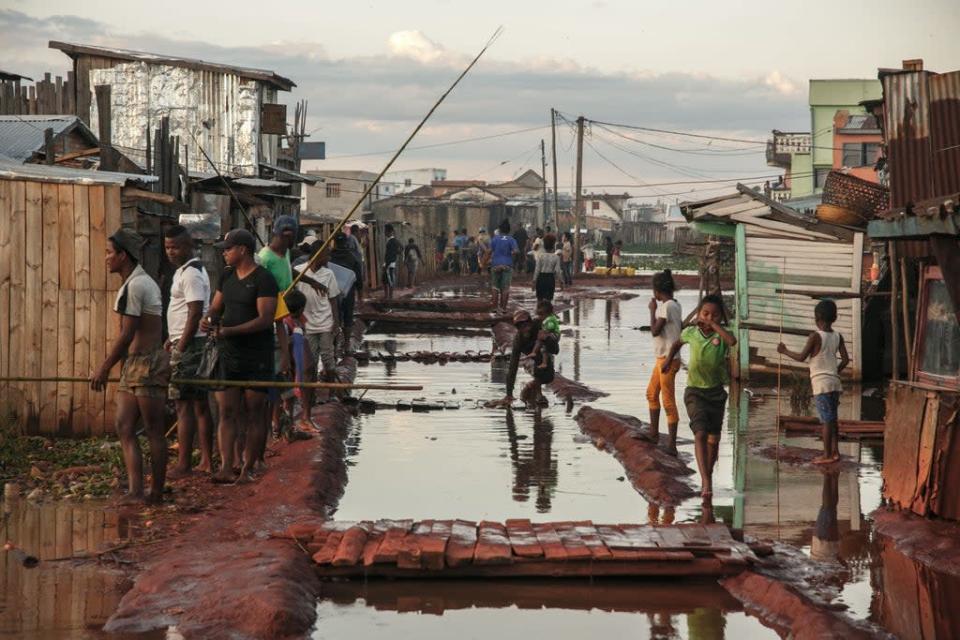 Residents of the Ankasina flooded neighbourhood stand in a flood area in Antananarivo, Madagascar in late January (AFP via Getty Images)