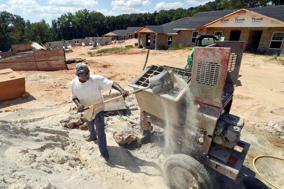 Michael Wallace fills up a mortar mixer while working at the Village Springs development in DeFuniak Springs in this Daily News photo from September 2019.