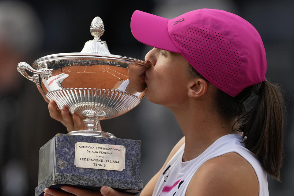 Iga Swiatek, of Poland, poses with her trophy after defeating Aryna Sabalenka, of Belarus, in the Italian Open tennis tournament final match at Rome's Foro Italico, Saturday, May 18, 2024. Swiatek won 6-2/6-3. (AP Photo/Alessandra Tarantino)