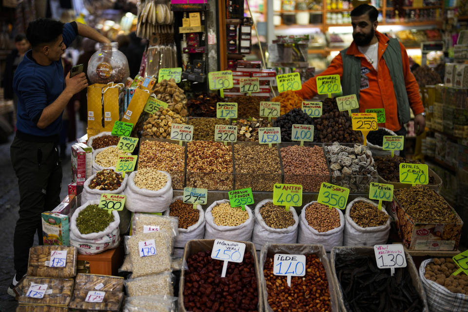 Sellers wait for customers in a food shop at Eminonu commercial area in Istanbul, Turkey, Wednesday, Feb. 7, 2024. Turkey's new Central Bank chief says tight fiscal policies to tame inflation will continue "with determination" forecasting a 14 per cent inflation rate by the end of 2025. (AP Photo/Francisco Seco)