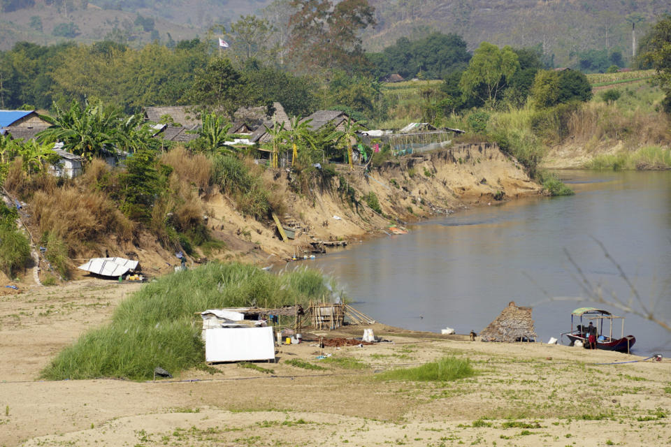 A camp for internally displaced people in Myanmar as seen across the Moei river from Mae Sot in western Thailand on Thursday, Feb. 8, 2024. Thailand's Foreign Minister Parnpree Bahiddha-Nukara was inspecting the staging area in Mae Sot on Thursday, from where cross border aid will be sent to displaced people in Myanmar beginning in about a month. (AP Photo/Jintamas Saksornchai)