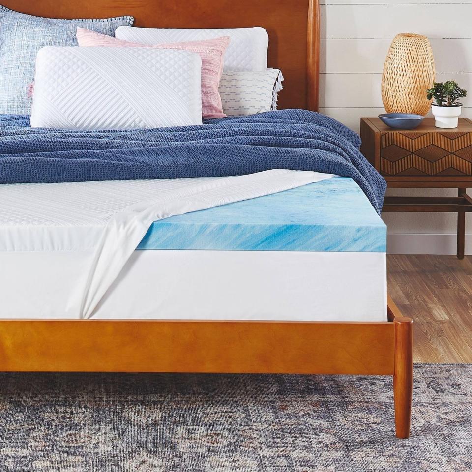 the blue topper and cover on a bed