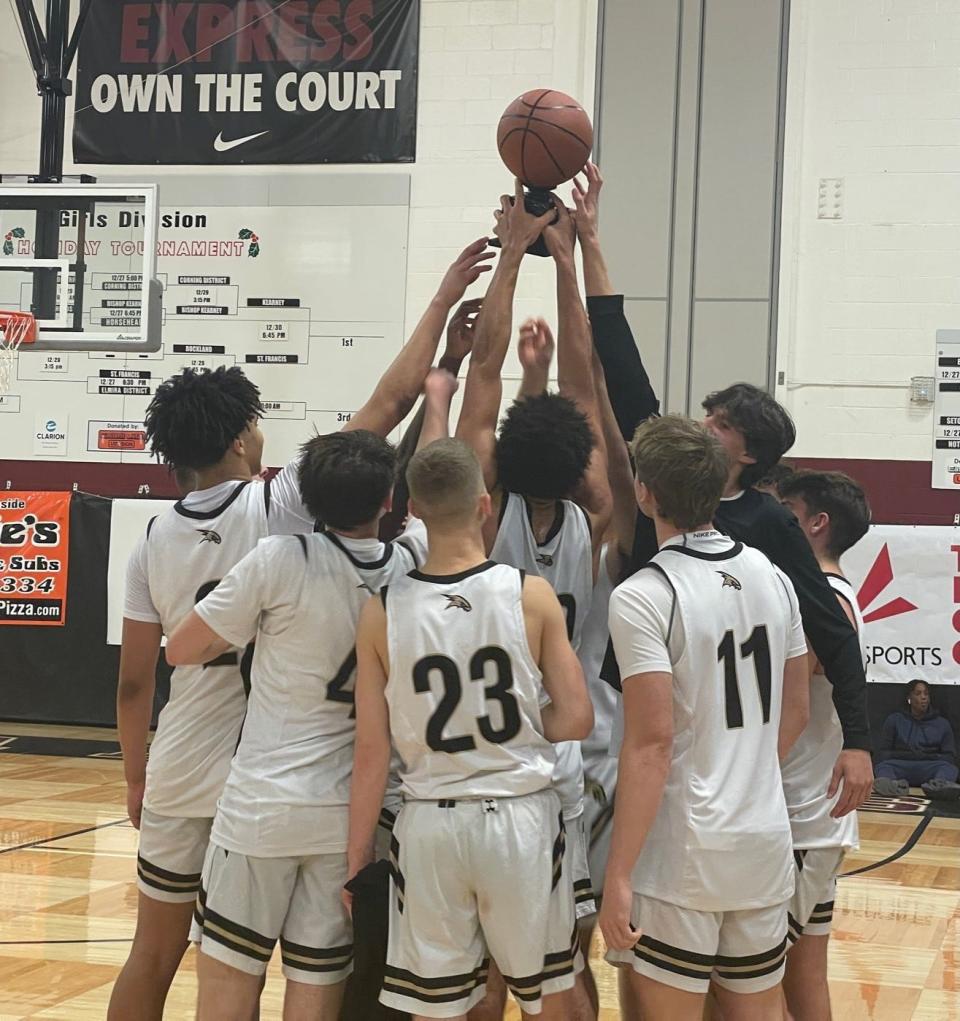 Corning's boys basketball team with its trophy after rallying for a 74-63 victory over Binghamton Seton Catholic Central in the Boys Regional Division 2 final at the Josh Palmer Fund Clarion Classic on Dec. 30, 2022 at Elmira High School.