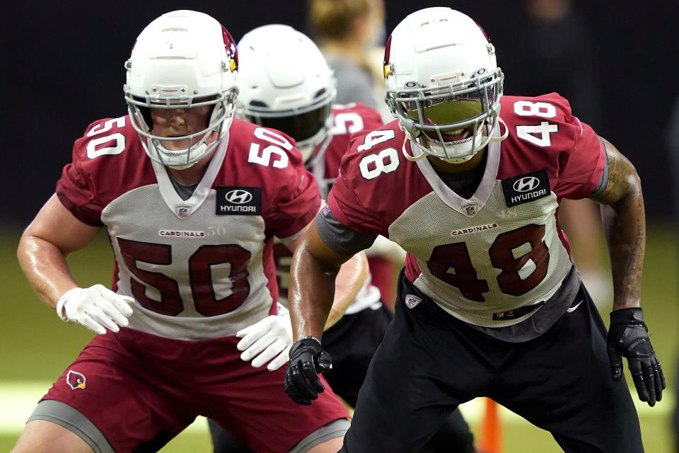 FILE - In this Aug. 31, 2020, file photo, Arizona Cardinals' Isaiah Simmons (48) and Evan Weaver (50) run drills during NFL football training camp in Glendale, Ariz. The Cardinals, who play the San Francisco 49ers this week, have added a dynamic No. 1 receiver in DeAndre Hopkins and a versatile defensive playmaker in rookie Simmons. (AP Photo/Matt York, File)