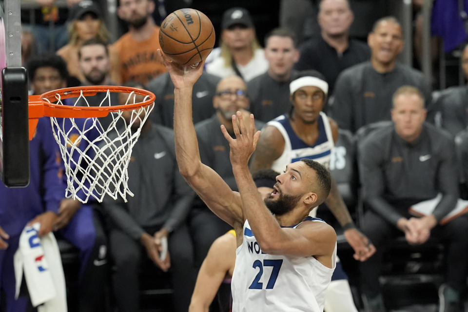 Minnesota Timberwolves center Rudy Gobert scores against the Phoenix Suns during the first half of Game 4 of an NBA basketball first-round playoff series, Sunday, April 28, 2024, in Phoenix. (AP Photo/Ross D. Franklin)