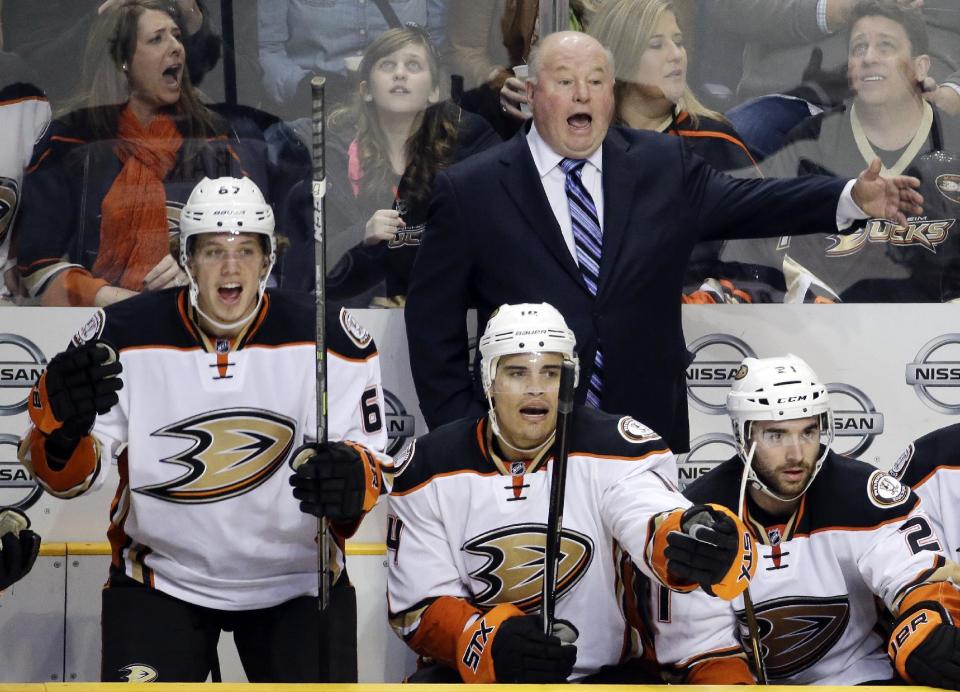 FILE- In this Feb. 5, 2015, file photo, Anaheim Ducks head coach Bruce Boudreau, rear; Rickard Rakell (67), of Sweden; and Rene Bourque (14) yell for a penalty call in the second period of an NHL hockey game against the Nashville Predators in Nashville, Tenn. When the Ducks clinched Boudreau&#39;s first trip to the Western Conference finals, the affable coach allowed himself &quot;five minutes of joy&quot; to celebrate the death of his old reputation. His spectacular regular-season success will no longer be overshadowed by his teams&#39; Stanley Cup playoff failures (AP Photo/Mark Humphrey, File)
