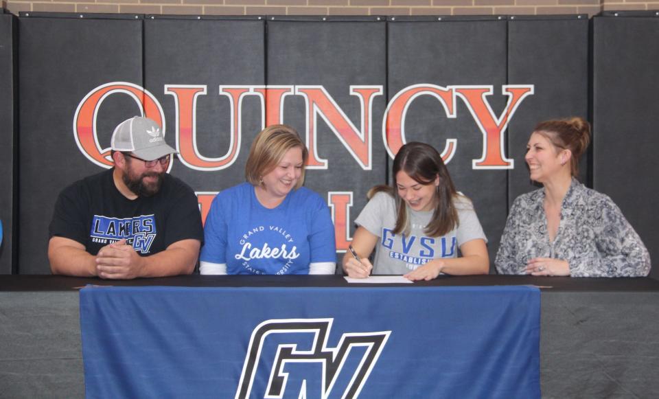 Quincy's Sophia Snellenberger is all smiles as she signs her letter of intent with Grand Valley State University