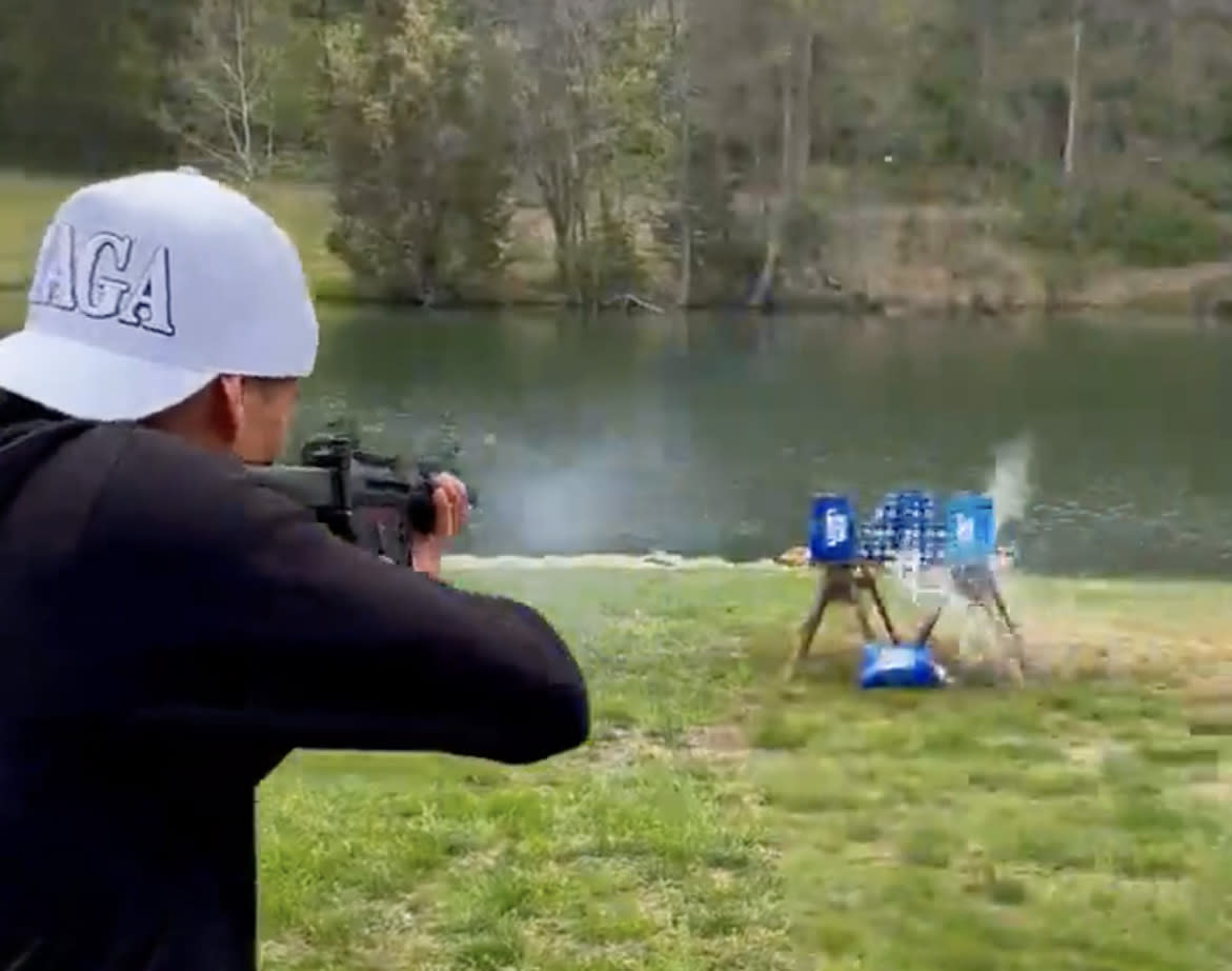 Kid Rock fires an assault-style rifle at Bud Light cans in an anti-trans protest. ( Kid Rock via Twitter)