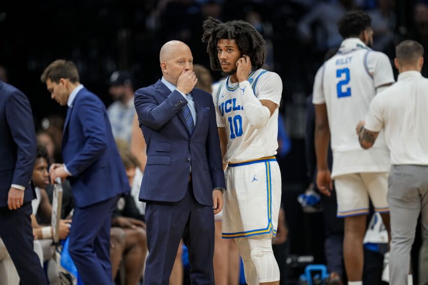 PHILADELPHIA, CA - MARCH 25: UCLA Bruins head coach Mick Cronin talks with UCLA Bruins guard Tyger Campbell.