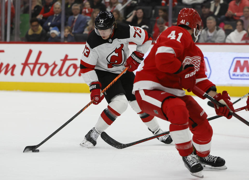 New Jersey Devils right wing Tyler Toffoli (73) shoots as Detroit Red Wings defenseman Shayne Gostisbehere (41) watches during the first period of an NHL hockey game Wednesday, Nov. 22, 2023, in Detroit. (AP Photo/Duane Burleson)