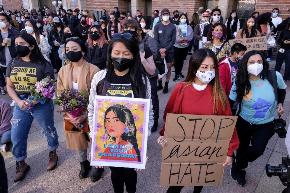Demonstrators wearing face masks and holding signs take part in a rally "Love Our Communities: Build Collective Power" to raise awareness of anti-Asian violence, at the Japanese American National Museum in Little Tokyo in Los Angeles, California, on March 13. (Photo: RINGO CHIU via Getty Images)