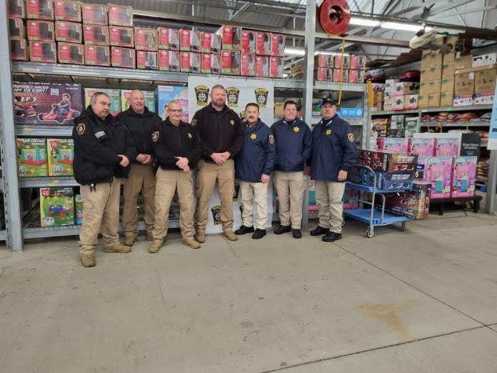 Law enforcement, including those from the Somerset County Sheriff's Office, right, help kids during a shopping event.