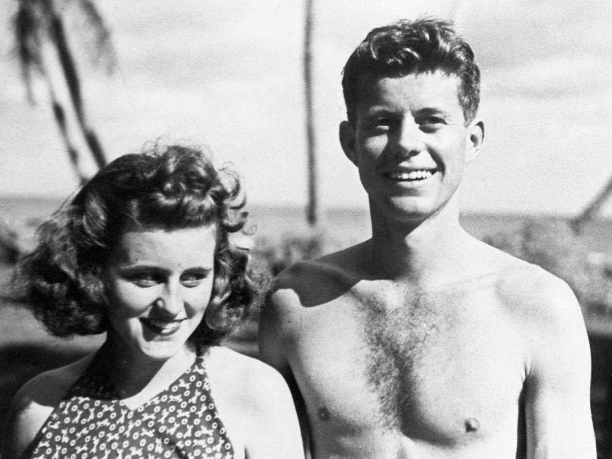 A black-and-white photograph of John F. Kennedy and Kathleen Kennedy in Palm Beach, Florida.