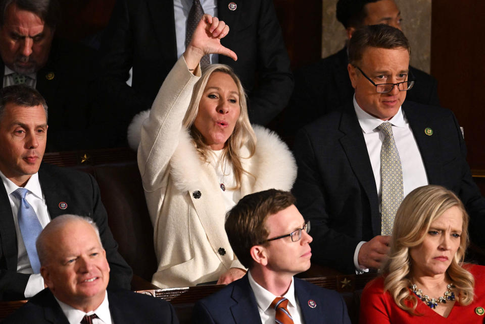 US Republican Representative Marjorie Taylor Greene (R-GA) gives a thumb down as US President Joe Biden delivers the State of the Union address at the US Capitol in Washington, DC, February 7, 2023. (Jim Watson / AFP - Getty Images)