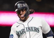 Seattle Mariners' Eugenio Suarez walks back to the dugout after flying out during the fifth inning of the team's baseball game against the Oakland Athletics on Tuesday, Aug. 29, 2023, in Seattle. (AP Photo/Lindsey Wasson)