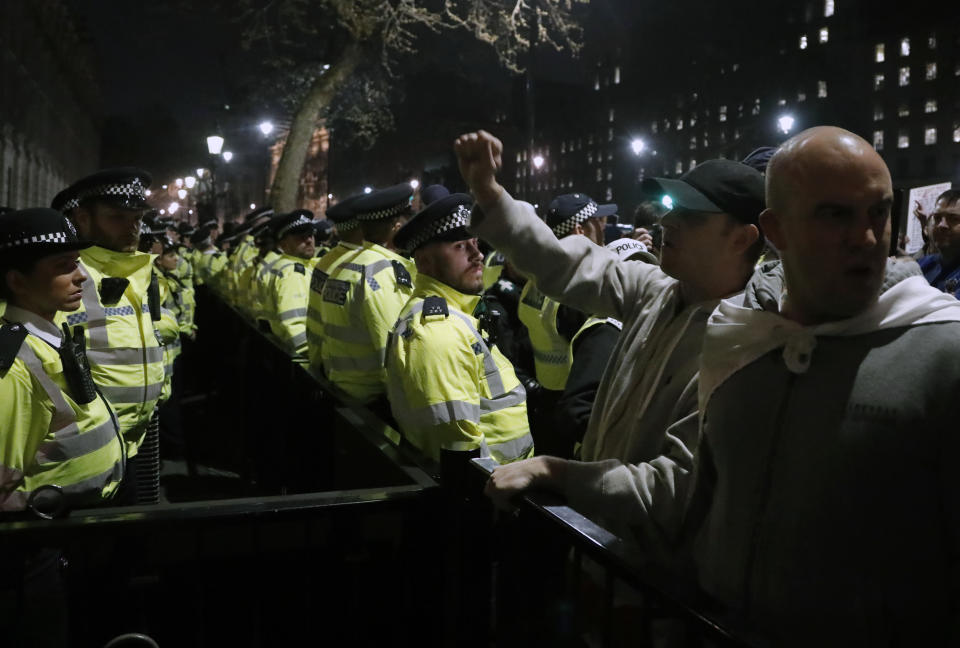 Pro-Brexit protesters clash with police after their rally in Westminster, London, Friday, March 29, 2019. Pro-Brexit demonstrators were gathering in central London on the day that Britain was originally scheduled to leave the European Union. British lawmakers will vote Friday on what Prime Minister Theresa May's government described as the "last chance to vote for Brexit." (AP Photo/ Frank Augstein)