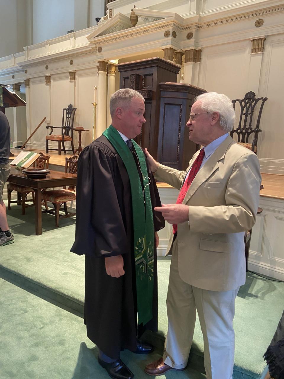 The Rev. Dr. Kyle Reese is congratulated by longtime member J. Curtis Lewis III