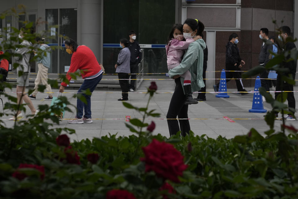 Residents wearing masks line up for mass Covid testing on Tuesday, May 10, 2022, in Beijing. China's capital began another round of three days of mass testing for millions of its residents Tuesday in a bid to prevent an outbreak from growing to Shanghai proportions. (AP Photo/Ng Han Guan)