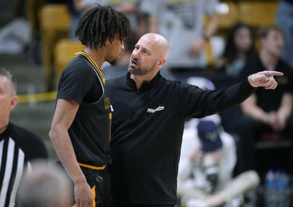 Milwaukee coach Bart Lundy, right, confers with guard BJ Freeman during the first half of the team's NCAA college basketball game against Colorado on Tuesday, Nov. 14, 2023, in Boulder, Colo. (AP Photo/David Zalubowski)