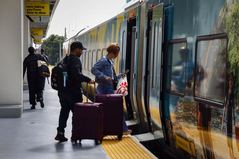 MIAMI, FLORIDA-Feb. 6, 2024-Passengers get onboard the train at the Brightline Fort Lauderdale Station in Fort Lauderdale, Florida, US, on Tuesday, February 6, 2024. (Eva Marie Uzcategui / Los Angeles Times)