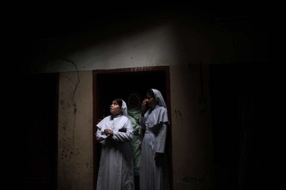 In this Thursday, March 14, 2013, photo, Franciscan nuns visit the remains of a Church after it was damaged by an angry Muslim mob in a Christian neighborhood, in Lahore, Pakistan. Pakistan’s blasphemy law has become a potent weapon in the arsenal of Muslim extremists, who use it against adherents of minority religions. (AP Photo/Nathalie Bardou)