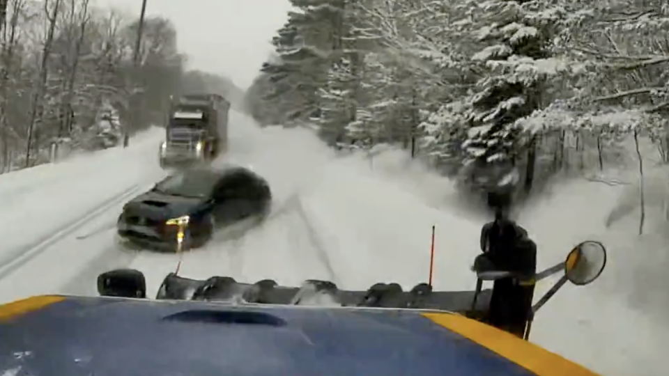 a car on a road with snow on the side