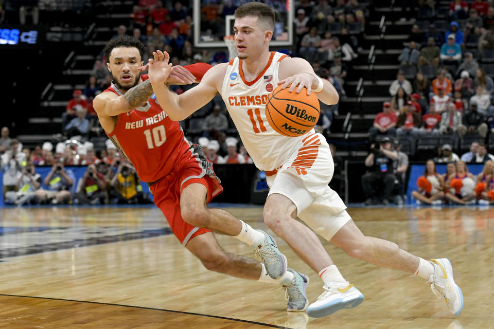 Clemson guard Joseph Girard III (11) dribbles the ball past New Mexico guard Jaelen House (10) during the first half of a first-round college basketball game in the NCAA Tournament, Friday, March 22, 2024, in Memphis, Tenn. (AP Photo/Brandon Dill)