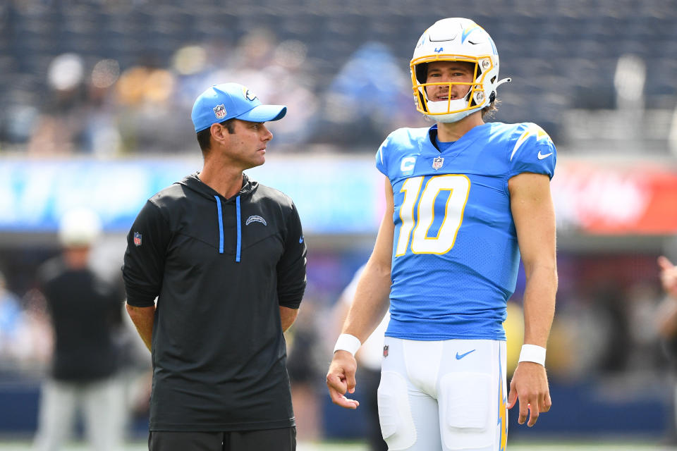 Los Angeles Chargers head coach Brandon Staley (left) need to find a good offensive coordinator to unlock the full potential of star quarterback Justin Herbert. (Photo by Brian Rothmuller/Icon Sportswire via Getty Images)