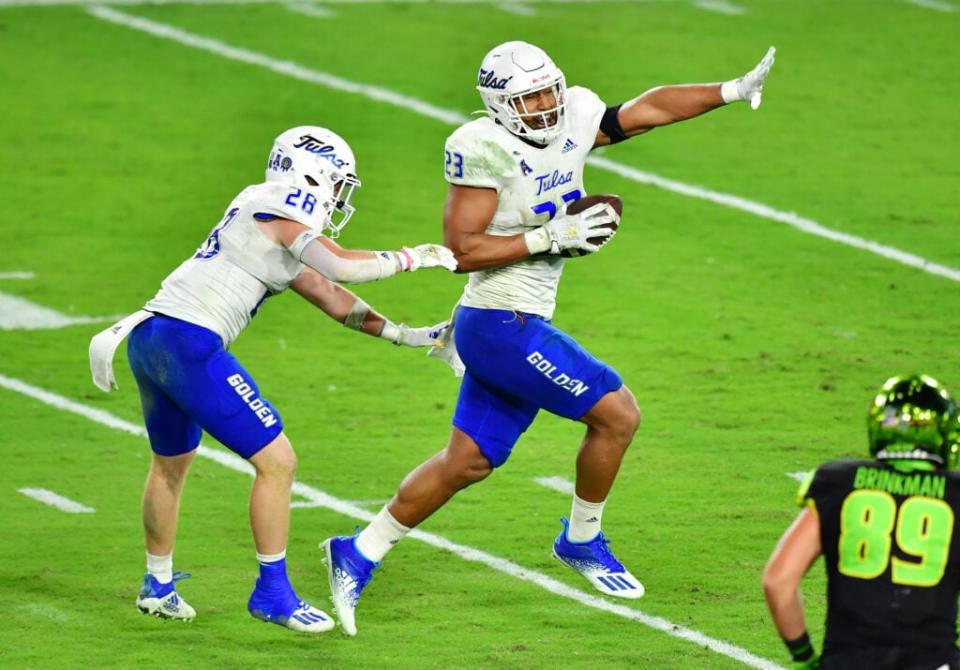 Zaven Collins #23 of the Tulsa Golden Hurricane celebrates after intercepting Noah Johnson #0 of the South Florida Bulls and running in a 38-yard touchdown during the third quarter at Raymond James Stadium on October 23, 2020 in Tampa, Florida. (Photo by Julio Aguilar/Getty Images)