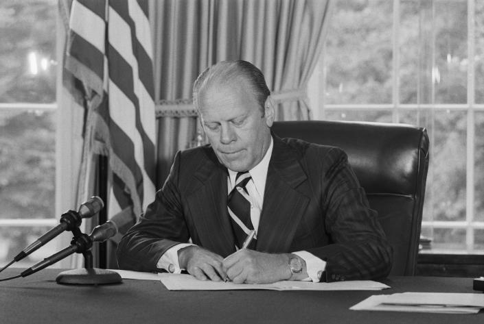 One month after Richard Nixon’s resignation over the Watergate scandal, President Ford signs his pardon in 1974. (Photo: Bettmann Archive via Getty Images)