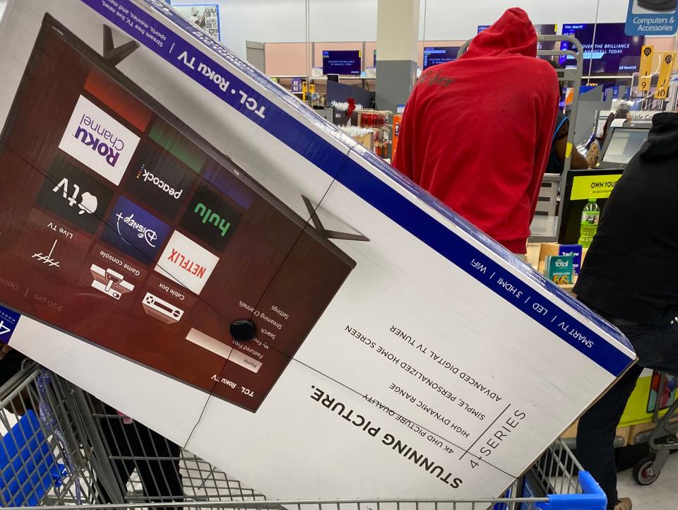 A TV in someone's cart at a Walmart on Black Friday