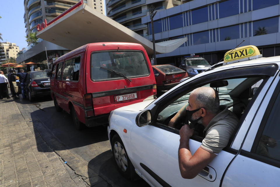 A taxi driver look out through his car, as he waits in a queue for gasoline in Beirut, Lebanon in Beirut, Lebanon, Friday in Beirut, Lebanon, Wednesday, June 23, 2021. Lebanon is struggling amid a 20-month-old economic and financial crisis that has led to shortages of fuel and basic goods like baby formula, medicine and spare parts. The crisis is rooted in decades of corruption and mismanagement by a post-civil war political class. (AP Photo/Hussein Malla)