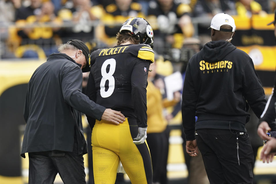 Pittsburgh Steelers quarterback Kenny Pickett (8) is helped off the field due to injury during the first half of an NFL football game against the Arizona Cardinals, Sunday, Dec. 3, 2023, in Pittsburgh. (AP Photo/Matt Freed)